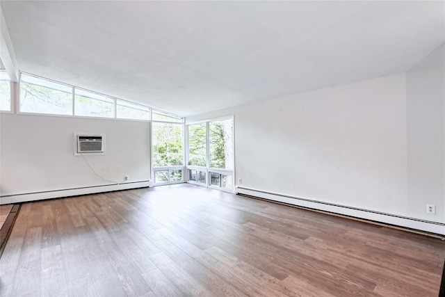 28 Robin Hood Rd, Montebello, NY 10901 - unfurnished room featuring a baseboard heating unit, wood finished floors, a wall mounted air conditioner, and lofted ceiling
