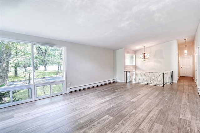 28 Robin Hood Rd, Montebello, NY 10901 - unfurnished room featuring a baseboard radiator, wood finished floors, and a chandelier