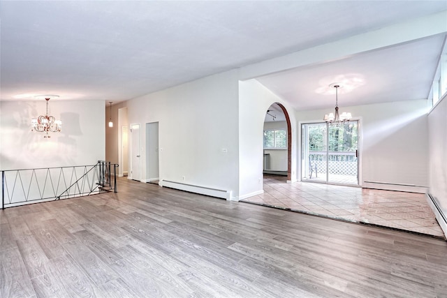 28 Robin Hood Rd, Montebello, NY 10901 - spare room with a chandelier, a baseboard heating unit, and wood finished floors