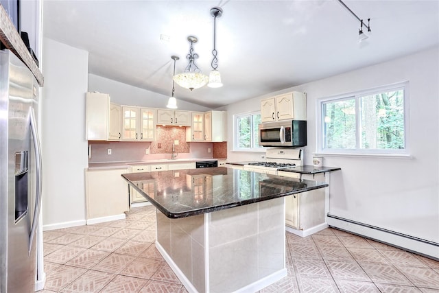 28 Robin Hood Rd, Montebello, NY 10901 - kitchen with appliances with stainless steel finishes, a baseboard radiator, light tile patterned floors, lofted ceiling, and a center island
