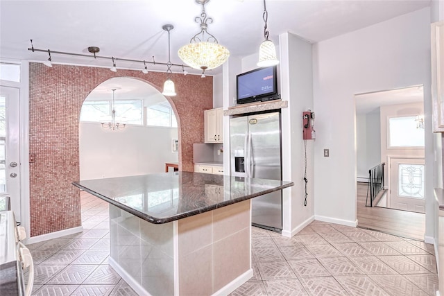 28 Robin Hood Rd, Montebello, NY 10901 - kitchen featuring stainless steel fridge with ice dispenser, a chandelier, light tile patterned floors, track lighting, and a kitchen island
