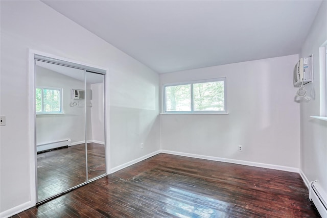 28 Robin Hood Rd, Montebello, NY 10901 - unfurnished bedroom featuring baseboard heating, vaulted ceiling, hardwood / wood-style floors, and a wall mounted AC
