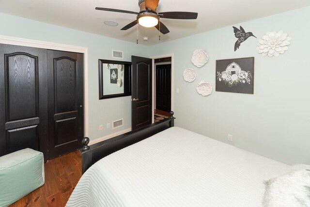 bedroom with ceiling fan, dark hardwood / wood-style floors, and a closet