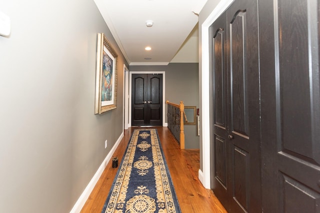 corridor featuring crown molding and wood-type flooring