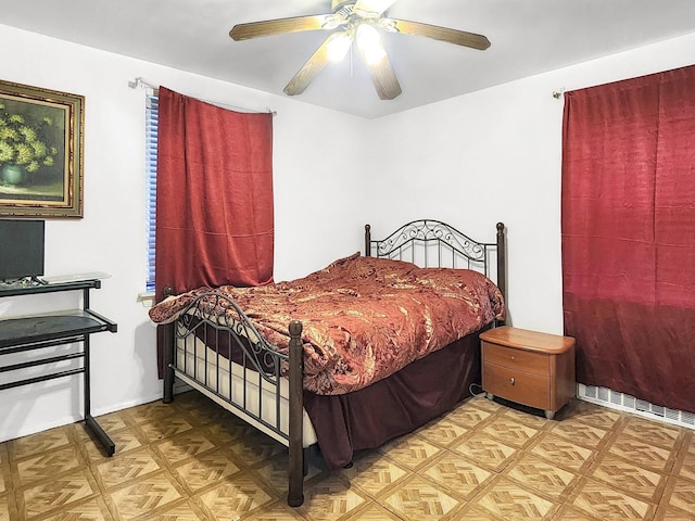 bedroom with parquet floors and ceiling fan