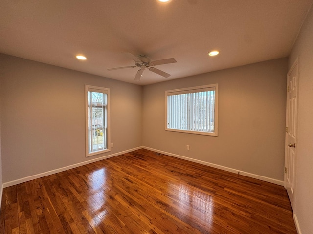 empty room with dark wood-type flooring and ceiling fan