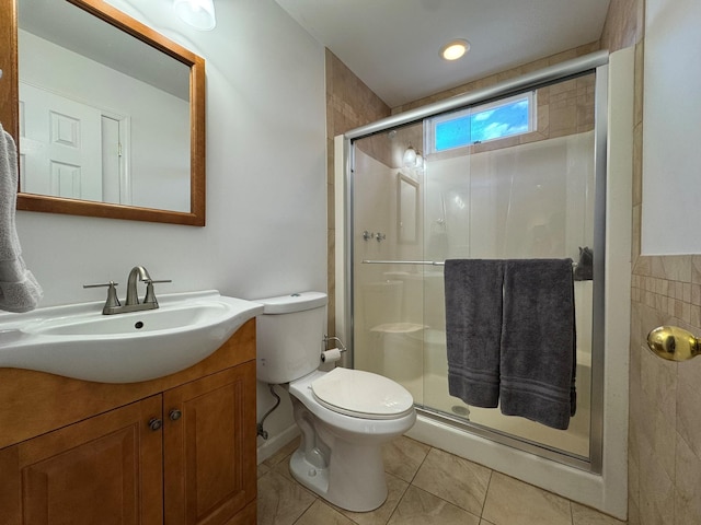 bathroom with a shower with shower door, vanity, toilet, and tile patterned floors