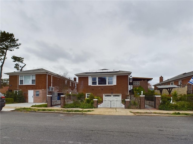 view of front of home featuring brick siding, solar panels, an attached garage, a gate, and fence