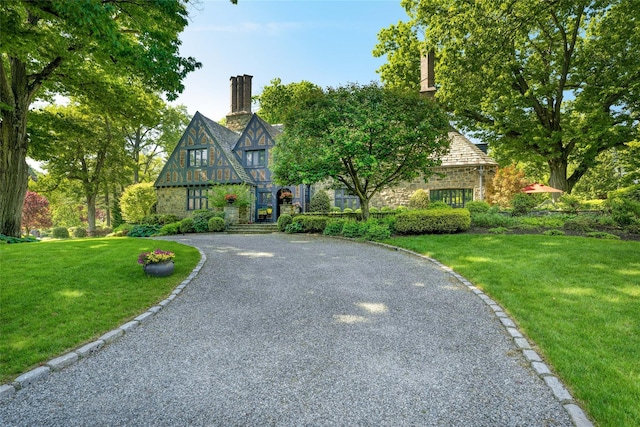 tudor home with a front yard