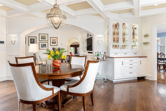 dining space with coffered ceiling, dark hardwood / wood-style flooring, beam ceiling, and a notable chandelier