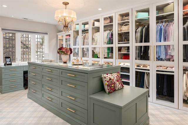 spacious closet with a notable chandelier