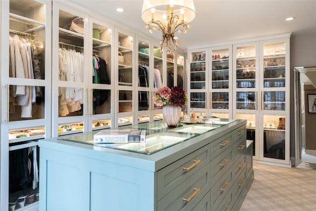 spacious closet featuring a chandelier