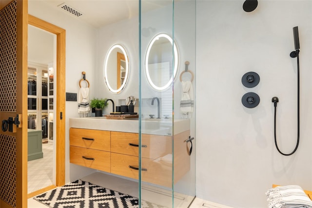 bathroom with walk in shower and vanity