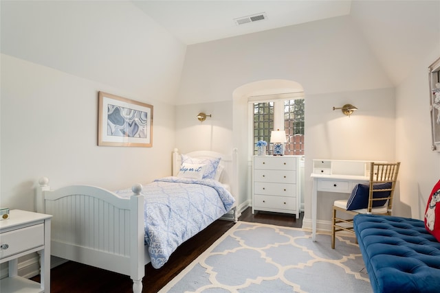 bedroom featuring dark wood-type flooring and vaulted ceiling