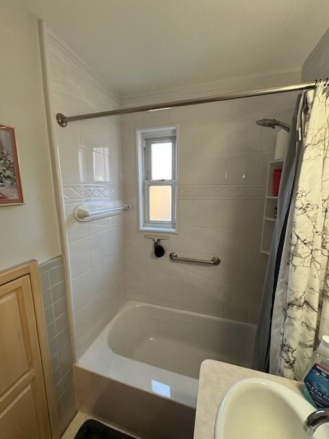 bathroom with sink and shower / bath combo with shower curtain