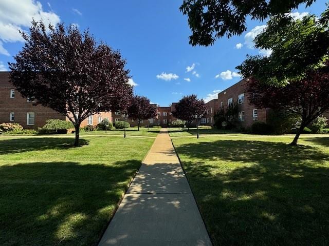 view of home's community featuring a lawn