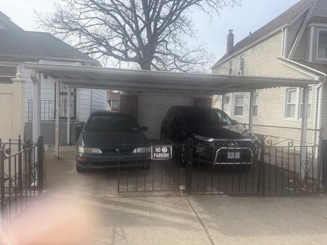 view of vehicle parking featuring a garage