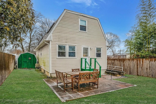 rear view of house with a storage shed, a patio area, and a lawn