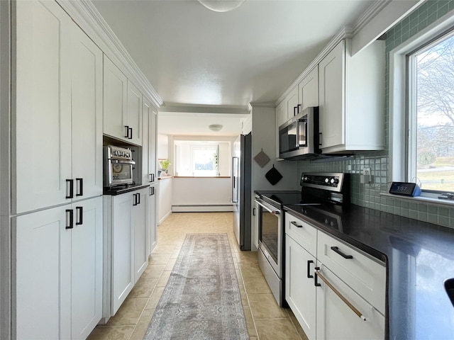 kitchen featuring white cabinetry, stainless steel appliances, decorative backsplash, and a baseboard heating unit