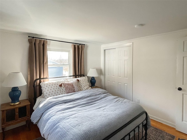 bedroom with hardwood / wood-style flooring and a closet