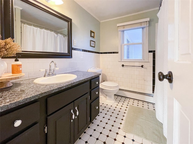 bathroom with crown molding, baseboard heating, tile walls, vanity, and toilet