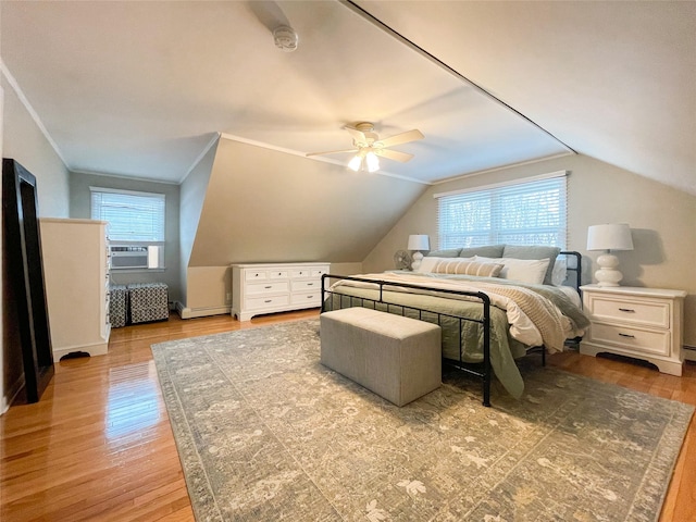 bedroom with lofted ceiling, baseboard heating, cooling unit, ornamental molding, and light wood-type flooring