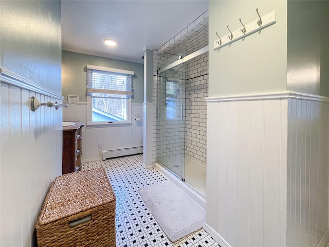 bathroom with vanity, an enclosed shower, and a baseboard heating unit