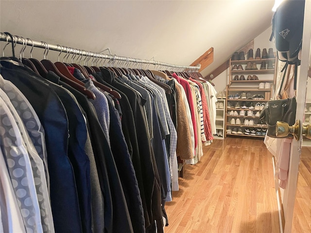 spacious closet featuring hardwood / wood-style floors and vaulted ceiling