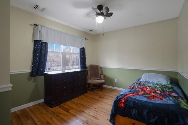 bedroom with ceiling fan and light hardwood / wood-style flooring