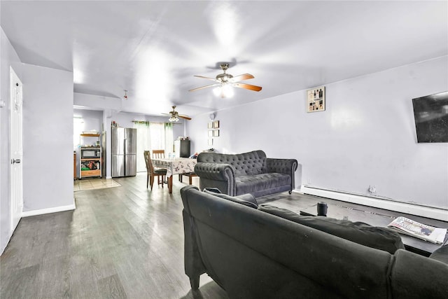 living room featuring wood-type flooring, ceiling fan, and baseboard heating