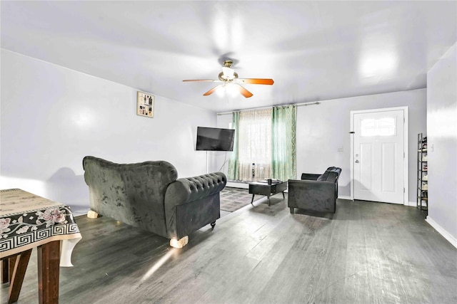 living room with ceiling fan, a baseboard radiator, and hardwood / wood-style floors