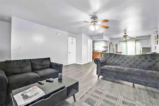 living room with ceiling fan and hardwood / wood-style floors