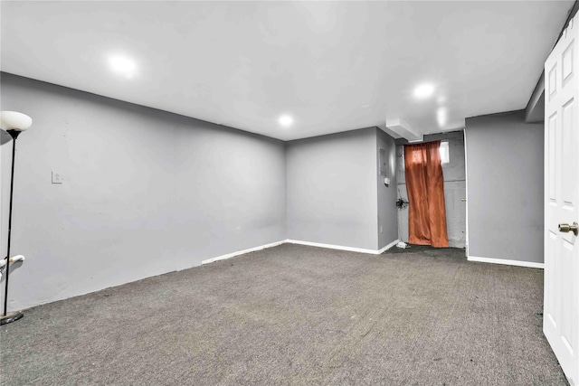 basement featuring dark carpet