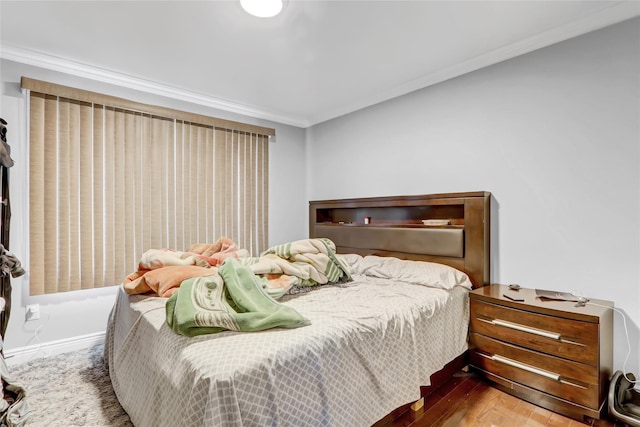 bedroom featuring hardwood / wood-style flooring and ornamental molding