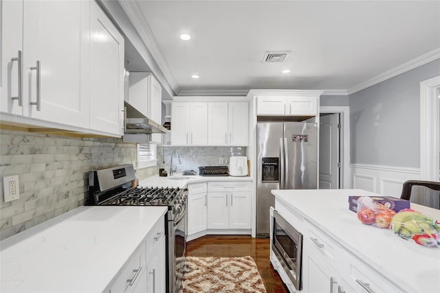 kitchen featuring crown molding, appliances with stainless steel finishes, sink, and white cabinets