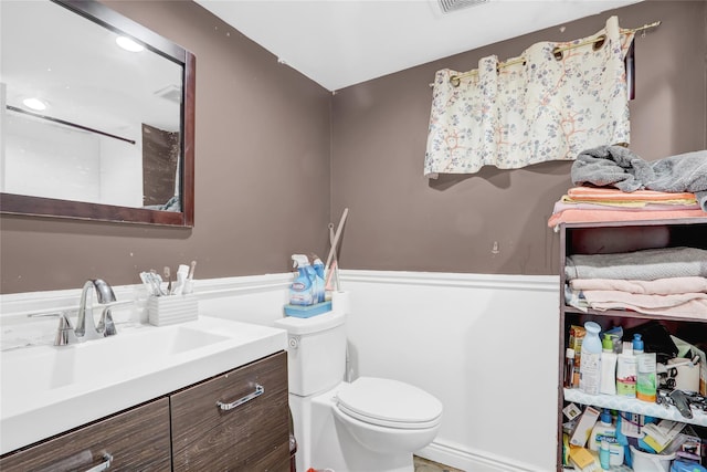 bathroom featuring vanity and toilet