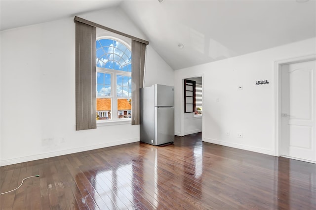 unfurnished room with vaulted ceiling and dark hardwood / wood-style flooring