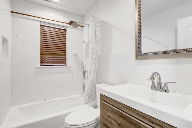 full bathroom featuring vanity, shower / tub combo, tile walls, and toilet