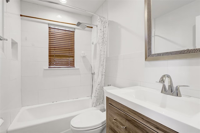 full bathroom featuring vanity, toilet, tile walls, and shower / bath combo