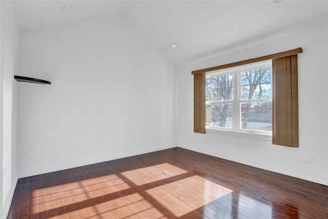 unfurnished room with dark hardwood / wood-style flooring and vaulted ceiling