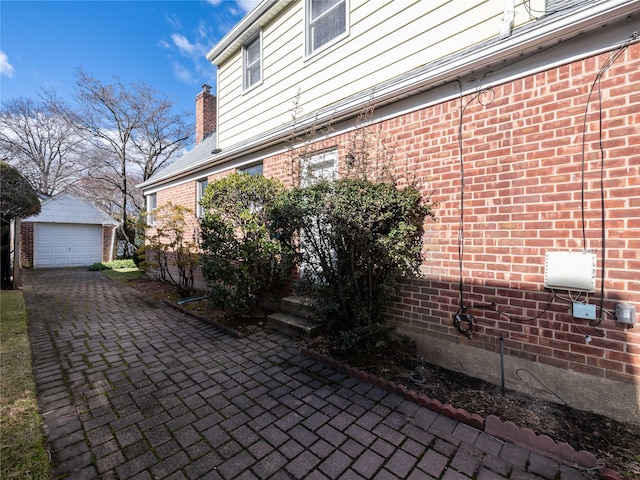 view of patio with a garage and an outdoor structure