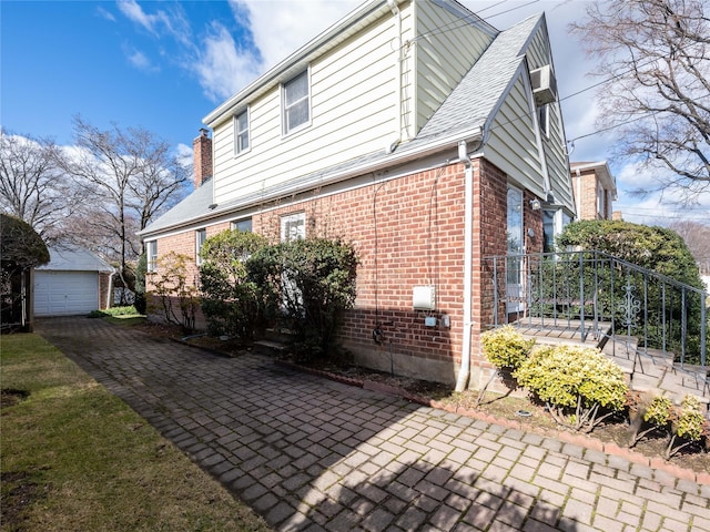 view of property exterior with a garage and an outdoor structure