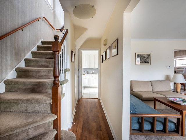 staircase featuring hardwood / wood-style flooring and cooling unit