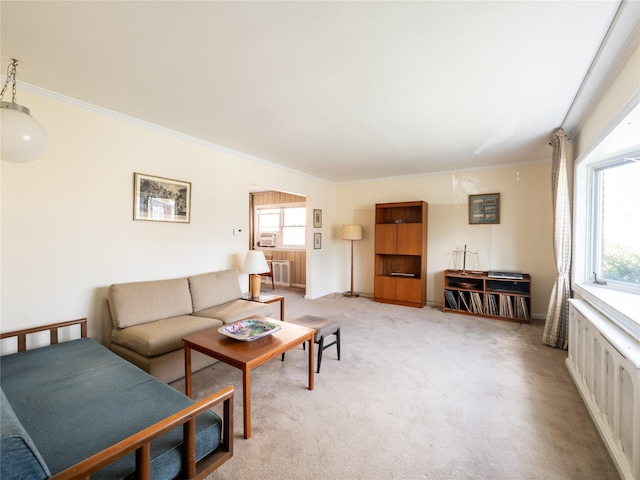 living room with crown molding, plenty of natural light, and light colored carpet