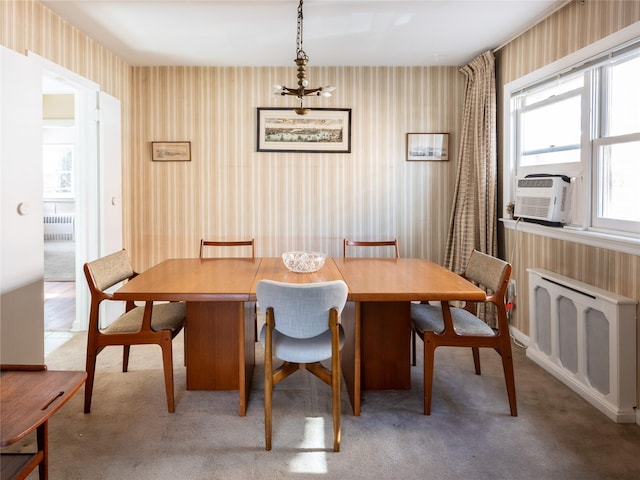 carpeted dining area featuring radiator and cooling unit