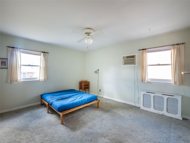 bedroom featuring ceiling fan, light colored carpet, and a wall mounted AC