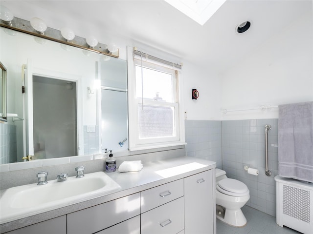 bathroom featuring radiator, a skylight, tile walls, tile patterned flooring, and toilet