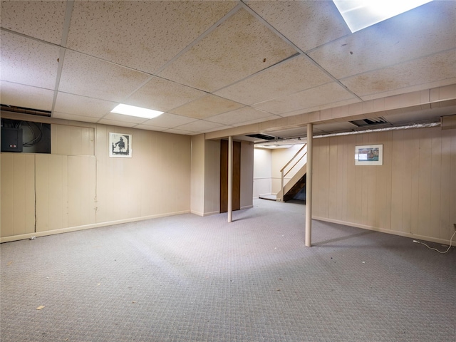 basement featuring carpet and a drop ceiling