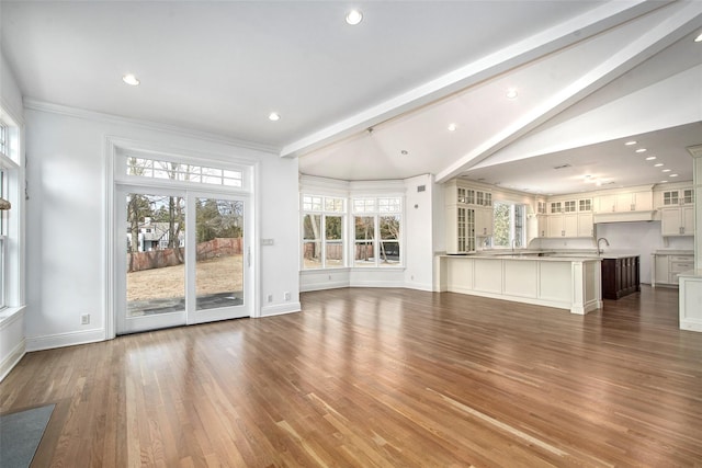 unfurnished living room with vaulted ceiling with beams, baseboards, dark wood-style flooring, and recessed lighting