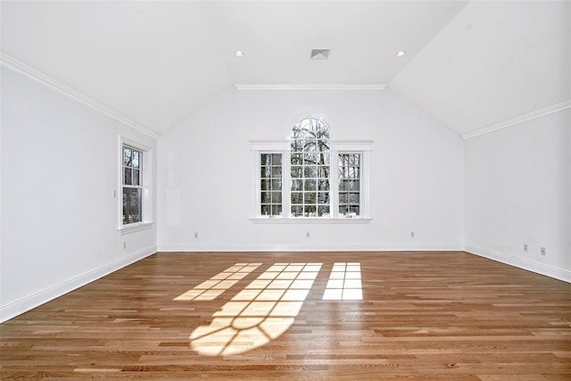 interior space featuring lofted ceiling, wood finished floors, visible vents, and baseboards